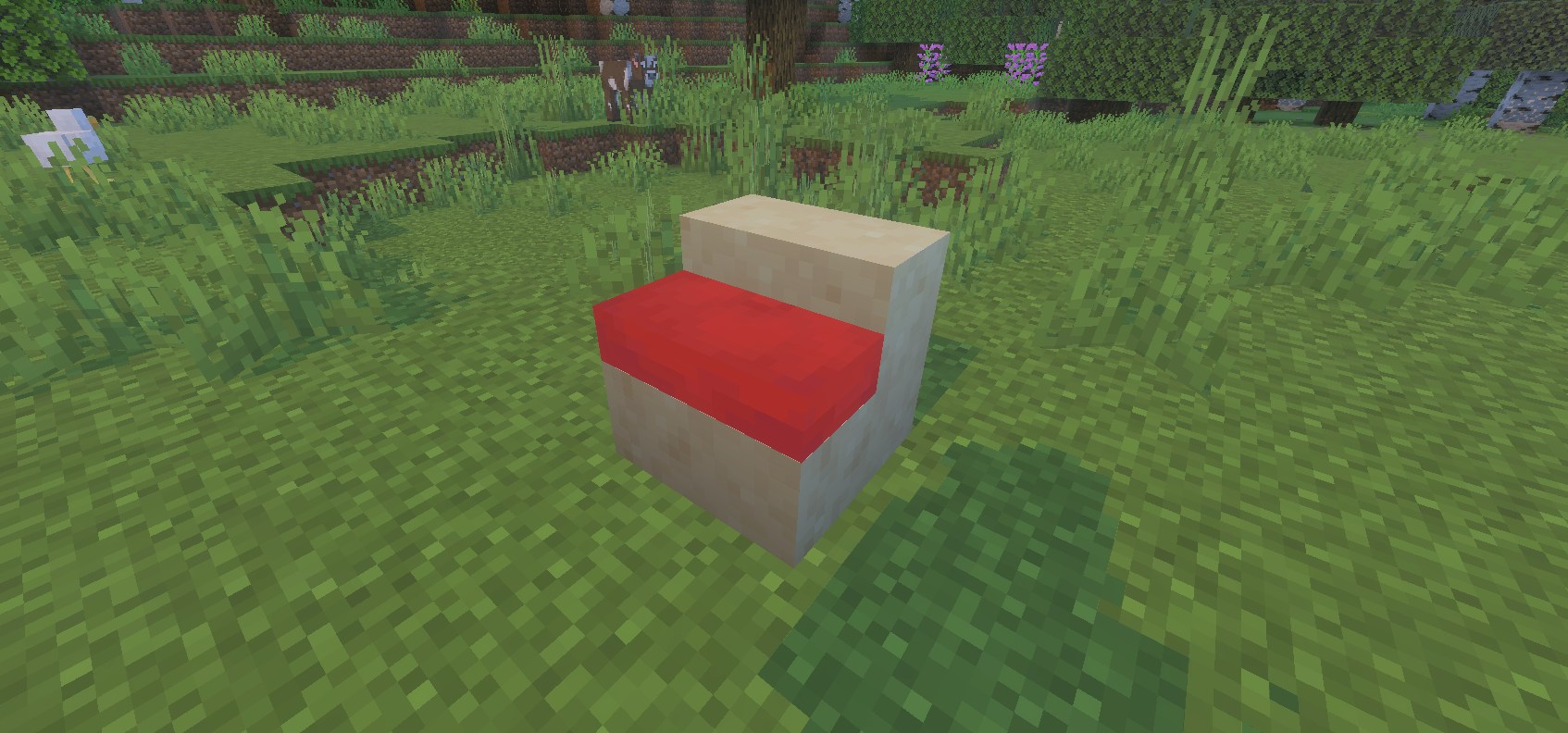 マイクラで階段の下の段に置いたクッションが上の段に半分ほど埋まっている様子