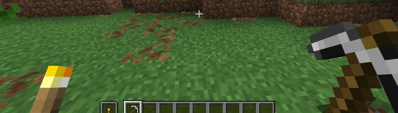 マイクラJava版で左手(オフハンド)にたいまつを持った様子